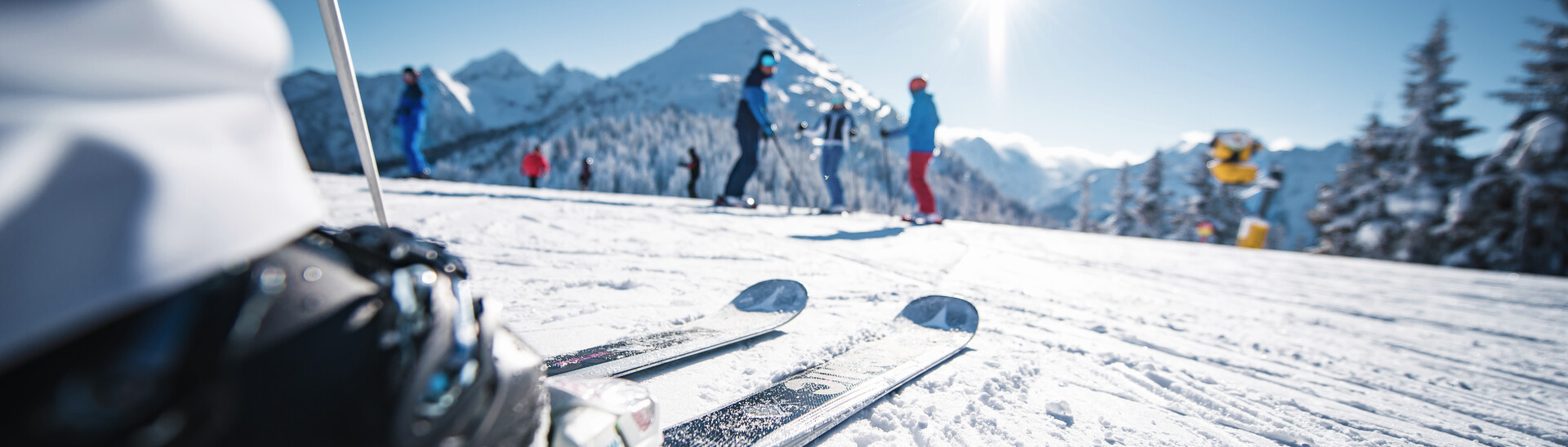 Skiers enjoy a sunny winterday in the ski area Snow Space in Salzburg
