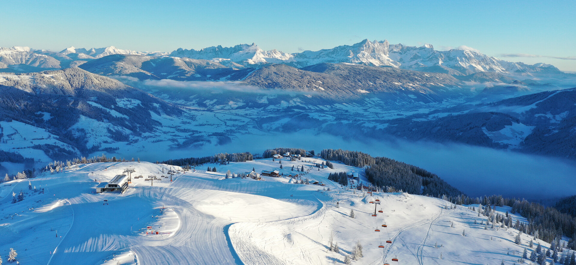 Panoramic view of the village of Flachau with a slope of Snow Space Salzburg in the foreground