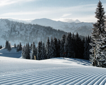 View to the just recently prepared slopes of the ski area St. Johann with sunshine